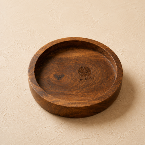 MOC-RT-CST-01 MOCCALO round wooden coaster with a recessed centre and raised rim on a cream background